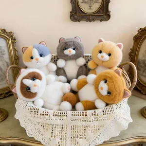 Set of five cute fluffy cat plush keychains in a white lace decorative basket.