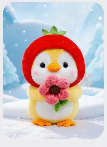Close-up of cute plush penguin doll wearing a strawberry hat and holding a pink flower.