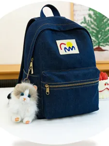 Denim backpack featuring a cute fluffy simulation cat plush keychain, stylish and practical daily bag.