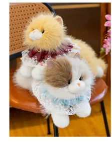 Close-up of two realistic Ragdoll cat plush toys with elegant lace collars on a chair