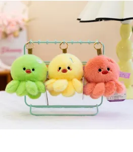 Detailed view of soft plush octopus keychains in green, yellow, and coral colors