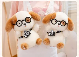 Close-up of two cute plush puppies with round glasses and miniature cameras