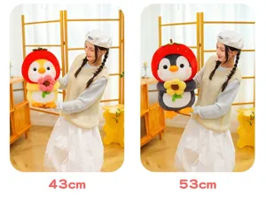 Comparison of 43cm and 53cm cute strawberry penguin plush toys held by model