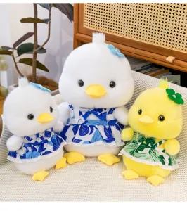 Three cute plush ducks wearing floral dresses on a cozy sofa, high detail view