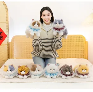 Various realistic plush Ragdoll cat toys with delicate lace collars on a cozy white bed