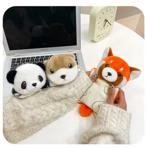 Detailed macro shot of cute panda, red panda, and capybara plush keychain pendants