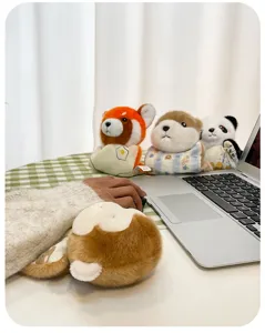 Detailed view of cute bean bag animal plush charms arranged around a laptop.