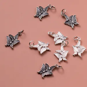 Detailed macro view of 925 sterling silver double butterfly charms with antique finish