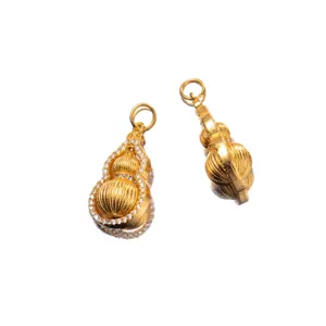 Detail view of gold-plated silver gourd pendants with micro-inlaid zirconia accents.
