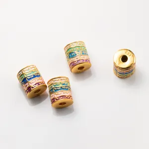 Close-up of S925 silver gold-plated barrel beads with colorful enamel scripture patterns