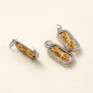 Detailed view of three rotatable S925 sterling silver Vajra pendants with vintage gold finish