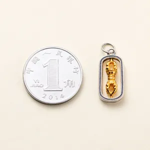 Size comparison of a rotatable 925 silver Vajra pestle pendant next to a coin.