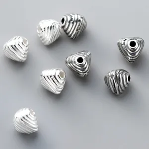 Detailed macro view of 925 sterling silver striped triangular spacer beads for DIY jewelry making