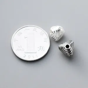 Close-up of 925 sterling silver vintage striped triangle spacer beads for DIY jewelry.