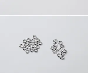 Close-up detail of S925 sterling silver open and closed jump rings for jewelry making.