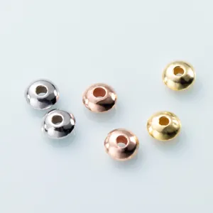 Close up of metallic spacer beads for DIY jewelry making, saucer shape, multi color pack.