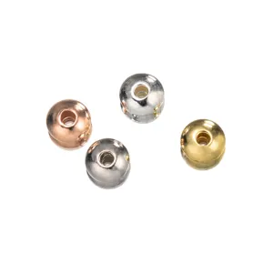 Detail view of four assorted metallic spacer beads in gold, silver, rose gold and gunmetal finishes.