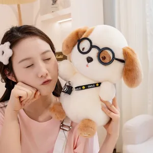 Cute plush dog toy with glasses and camera being held by a young woman