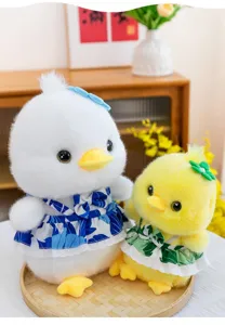 Adorable white and yellow plush duck toys wearing blue and green floral dresses