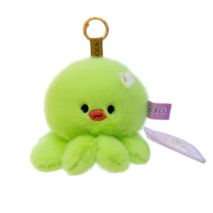 Adorable green fluffy octopus plush keychain with white flower detail for backpack charm