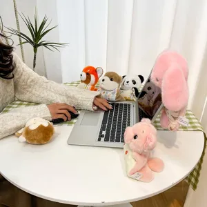 Set of cute plush animal pendants for backpacks and keychains on office desk