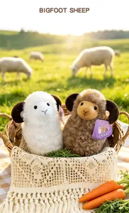 Two adorable bighorn sheep plush toys sitting in a basket on a sunny green pasture field
