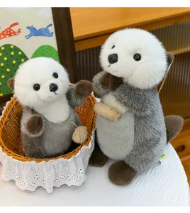 Close-up of two adorable sea otter plush toys with magnetic paws in a warm cozy setting