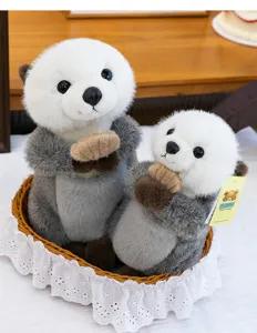 Detailed shot of two cute sea otter plush toys in a white lace basket with soft fur