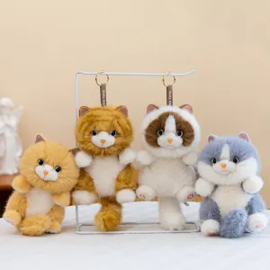 Set of four cute long-haired plush cat keychains in various realistic colors