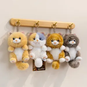 Cute long-haired cat plush keychains in various colors hanging on decorative wooden hooks