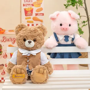 Adorable dressed teddy bear and pink pig plush toy set displayed on a white bench
