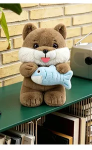 Macro detail of a cute brown plush cat holding a soft blue fish on a decorative shelf