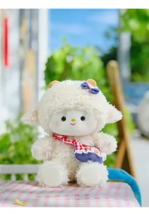 Close-up van een schattig wit pluche lammetje met rood geblokte sjaal en blauwe tas.