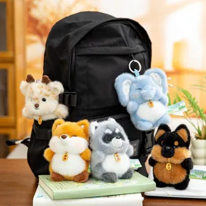 Five cute animal plush keychain charms hanging on a black backpack