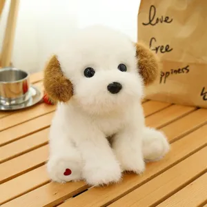 Adorable white and brown plush puppy dog toy sitting on a rustic wooden slatted table