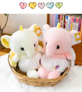 Two cute pastel plush elephant unicorn toys sitting in a cozy woven basket gift