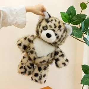 Adorable leopard pattern plush animal toy held by hand against a minimalist background
