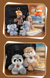 Close-up of various cute plush forest animal keychains attached to a black backpack.