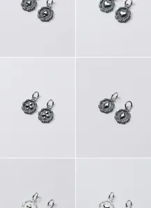 Macro view of vintage S925 sterling silver playing card suit charms with textured borders