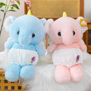 Pair of cute blue and pink elephant plush toys wearing diaper pants on white fur rug