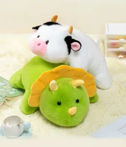 Adorable plush cow and green triceratops dinosaur toys on soft white rug detail view