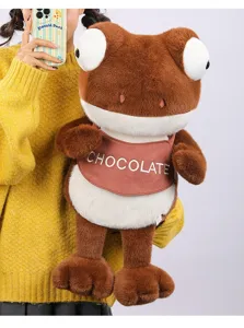 Large brown Maillard plush chameleon doll with chocolate bib being held by a person