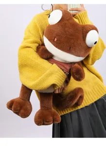Soft Maillard plush chameleon toy held by model to demonstrate large cuddle size