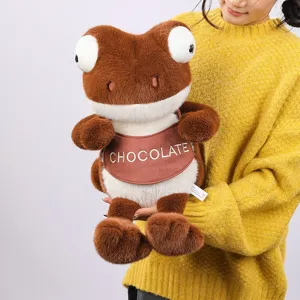 Cute Maillard style plush chameleon doll being held by a model in a yellow sweater