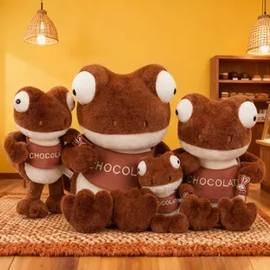 Maillard brown plush frog dolls in various sizes sitting in cozy cafe setting