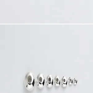 Close-up view of graduated S925 sterling silver flat wheel spacer beads for bracelet DIY crafting.