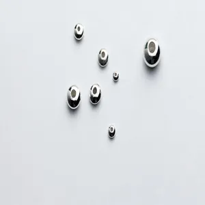 Closeup view of S925 sterling silver flat spacer beads, ideal for DIY crystal bracelets.