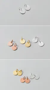 Close-up of 6mm S925 silver round charms with sand-blasted texture and engravings