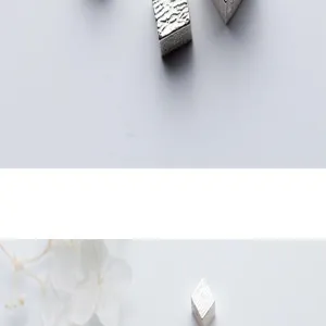 Macro detail of S925 sterling silver striped square cube beads for jewelry making