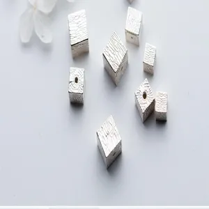 Close-up view of textured S925 sterling silver square beads for unique DIY jewelry making